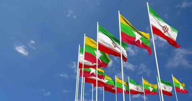 Myanmar, Burma and Iran Flags Waving Together in the Sky, Seamless Loop in Wind, Space on Left Side for Design or Information, 3D Rendering video