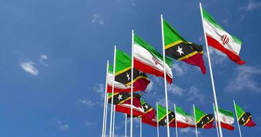 Saint Kitts and Nevis and Iran Flags Waving Together in the Sky, Seamless Loop in Wind, Space on Left Side for Design or Information, 3D Rendering video