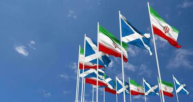 Scotland and Iran Flags Waving Together in the Sky, Seamless Loop in Wind, Space on Left Side for Design or Information, 3D Rendering video