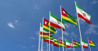 Togo and Iran Flags Waving Together in the Sky, Seamless Loop in Wind, Space on Left Side for Design or Information, 3D Rendering video