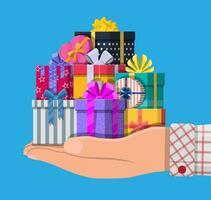 Gift boxes in hand. Colorful wrapped. Sale, shopping. Present boxes different sizes with bows and ribbons. Collection for birthday and holiday. Vector illustration in flat style