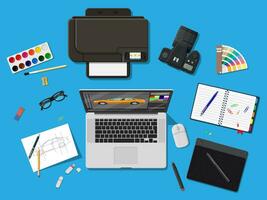 Designer workplace. Illustrator desktop with tools. Laptop pc, photo camera, mouse, glasses, notes, pen, printer. Sketch on paper blank and graphic tablet. Vector illustration in flat style