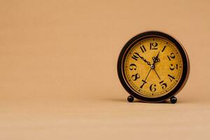 Brown vintage alarm clock Photo of a stationary clock, concept of time and how time works.