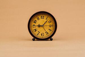 Brown vintage alarm clock Photo of a stationary clock, concept of time and how time works.