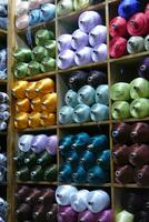 Multi - colored threads on shelves photo