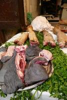 Tripe, hooves and meat  in a butcher shop photo