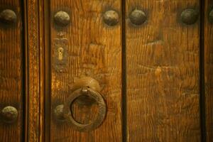 Very old wooden door with knocker photo