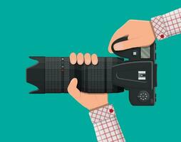 Modern photo camera in hand. Professional device for phototrophs telescopic lens. Vector illustration in flat style