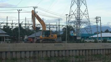 Gorontalo, Indonesia - 14 Dec 2023 - Projects of river widening and the construction of dykes around the Limboto Lake area. photo