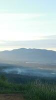 Beautiful sunrise over the mountain range at Gorontalo, Indonesia.  fluffy clouds on a bright blue sky. nature freshness concept photo