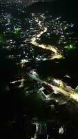 The vehicles driving on illuminated highway roads in the city at night photo