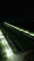 Deserted street at night. Row of street lights on the edge of Lake Limboto, Gorontalo-Indonesia photo