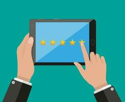 Hand holding and pointing tablet pc with five star rating on screen. Rating and review concept. vector illustration in flat style