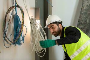 Engineers working on construction site, they are monitoring the building's electrical system. photo