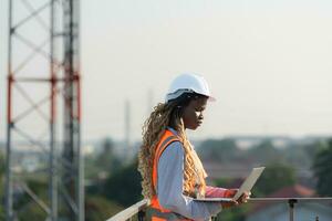 Engineer working on a building site The telephone and internet network signal systems of the construction building are being inspected. photo