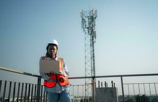 Engineer working on a building site The telephone and internet network signal systems of the construction building are being inspected. photo