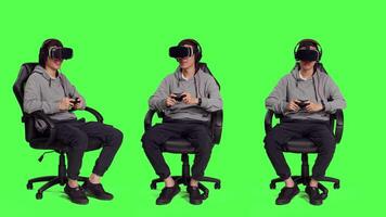 Man engages in internet gameplay clash with friends while playing video games using mobile devices against greenscreen backdrop. With virtual reality glasses, person looks confident.