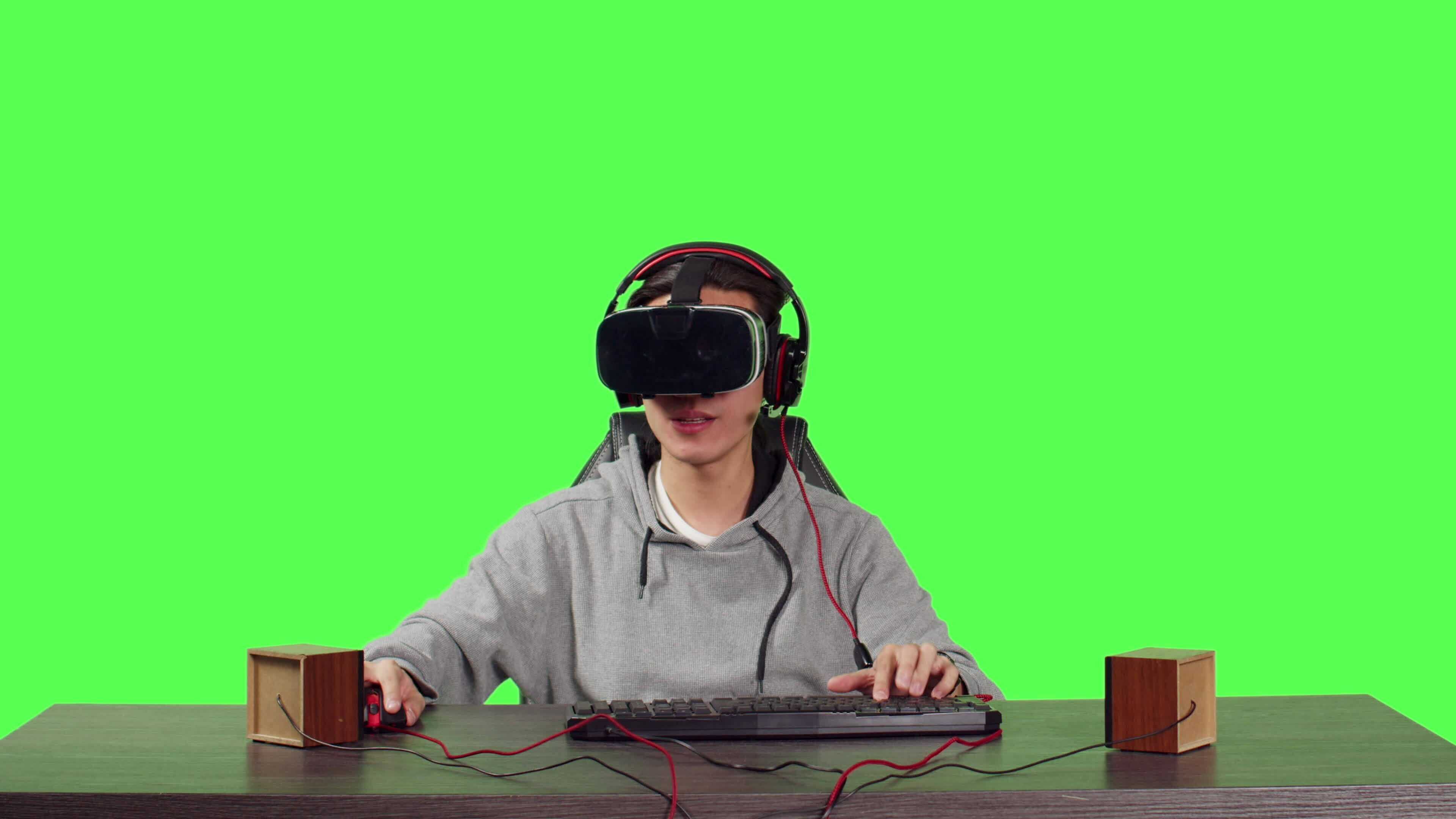 POV of person seated at workstation over full body greenscreen