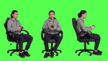 Young gamer playing videogames over full body greenscreen template, using joystick and enjoying competition with people online. Person having fun with rpg action contest on console. video