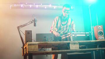 Woman artist mixing records and vinyl for disco tunes, having fun with disc mixing turntables for modern clubbing event. Funky musician using audio dj instruments to play techno songs. Handheld shot. video