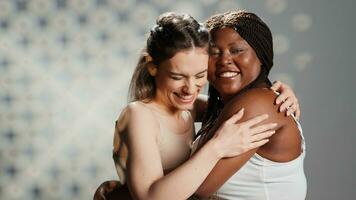 Cheerful women with radiant skin posing for beauty ad, showing self confidence and self acceptance. Young diverse girls promoting body positivity and posing with femininity, wellness. photo