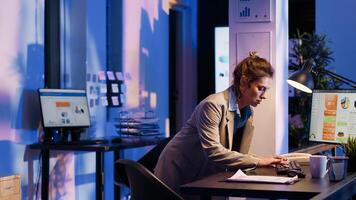 Business woman analyzing statistics on monitor and finishing management project before job deadline. Advisor agent working on financial diagrams and checking company analytics. photo