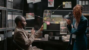 Police partners analyzing smartphone with greenscreen, using isolated template in incident room. Two private investigators looking at mobile phone display with chroma key copyspace. photo