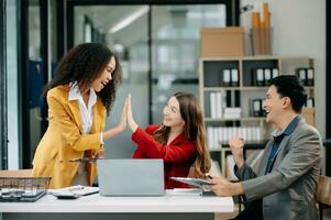 Office colleagues have a casual discussion. During a meeting in a conference room, a group of business teem sit in the room new startup project. photo