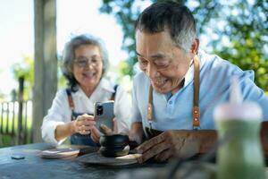 In the pottery workshop, an Asian retired couple is engaged in pottery making and clay painting activities. photo