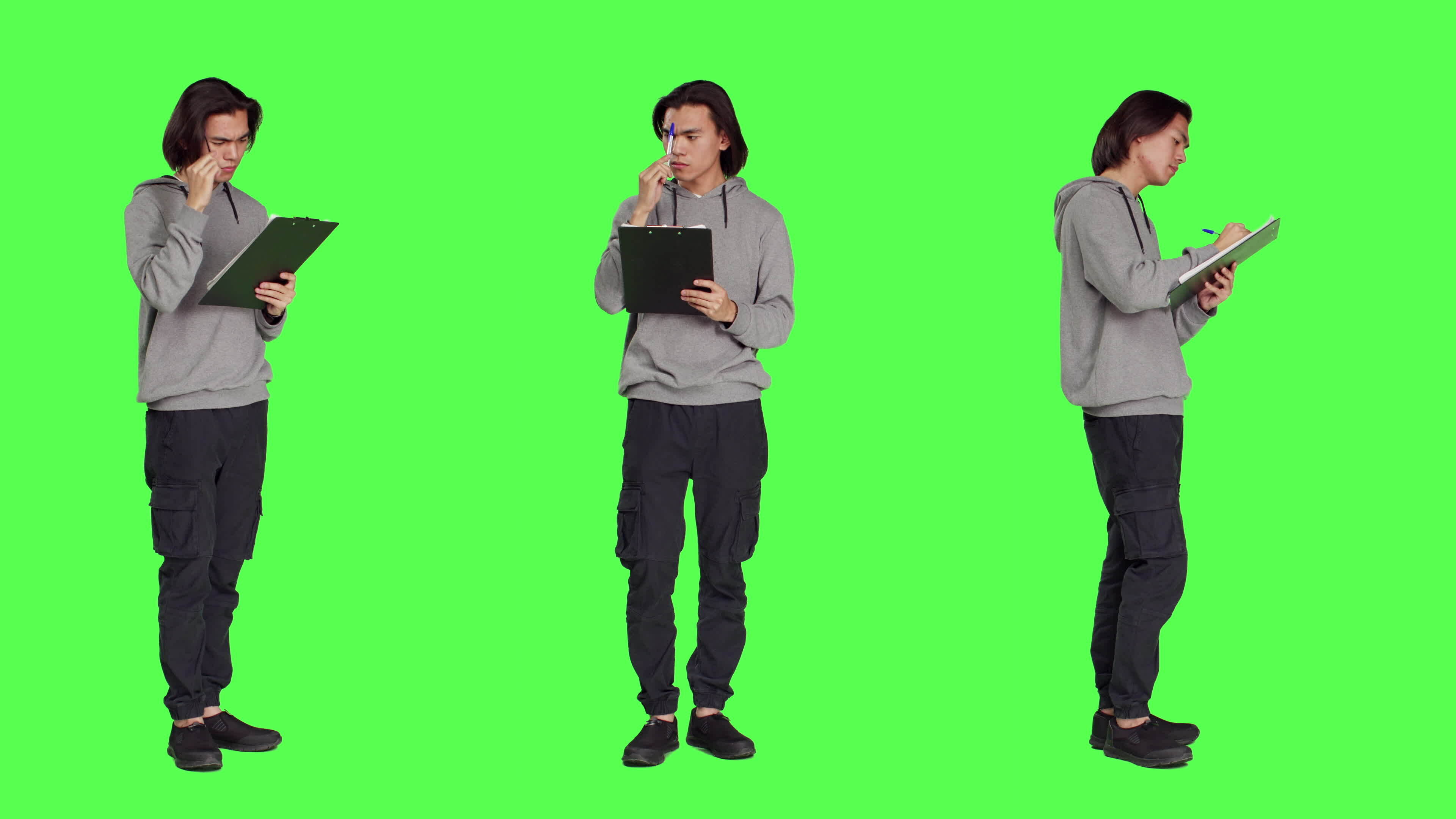 Asian adult taking notes and thinking about ideas to write on clipboard