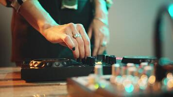 Young performer using dj electronics and headset to mix techno music and play remix songs on turntables, having fun at nightclub. Woman with crazy makeup mixing instruments. Close up. Handheld shot. video