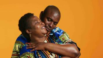 Caring husband hugging his wife in front of camera, showing honest feelings and true love for his life partner. African american couple embracing and presenting their sincere emotions. video