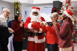 Person announces raffle winner at mall, reading name on paper extracted at giveaway contest during winter holiday. Workers creating fun competition for clients to enjoy shopping. photo