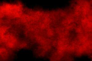 Red powder explosion cloud on black background. photo