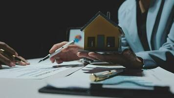 agente di intermediazione immobiliare in fase di analisi e prendere la decisione di un mutuo per la casa al cliente di firmare documenti contrattuali per l'acquisto di immobili, i dipendenti della banca raccomandano l'approvazione del mutuo ipotecario. video