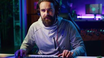 Cheerful gamer unaffected by losing match with teammates while playing competitive esports tournament. Man being optimistic in spite of loss while enjoying multiplayer videogame with friends video