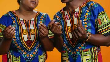 Serious husband and wife asking for salary in studio, rubbing their fingers to ask for cash payment or loan. Ethnic people in poverty demanding money income, financial difficulties. Close up. video