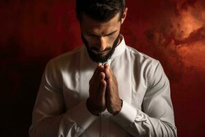 AI generated A man in a white shirt clasping his hands together in prayer or contemplation. photo