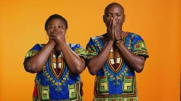 African american people doing three wise monkeys sign, covering their eyes, mouth and ears. Ethnic married couple advertising symbol to dont hear, speak or see bad evil things. video