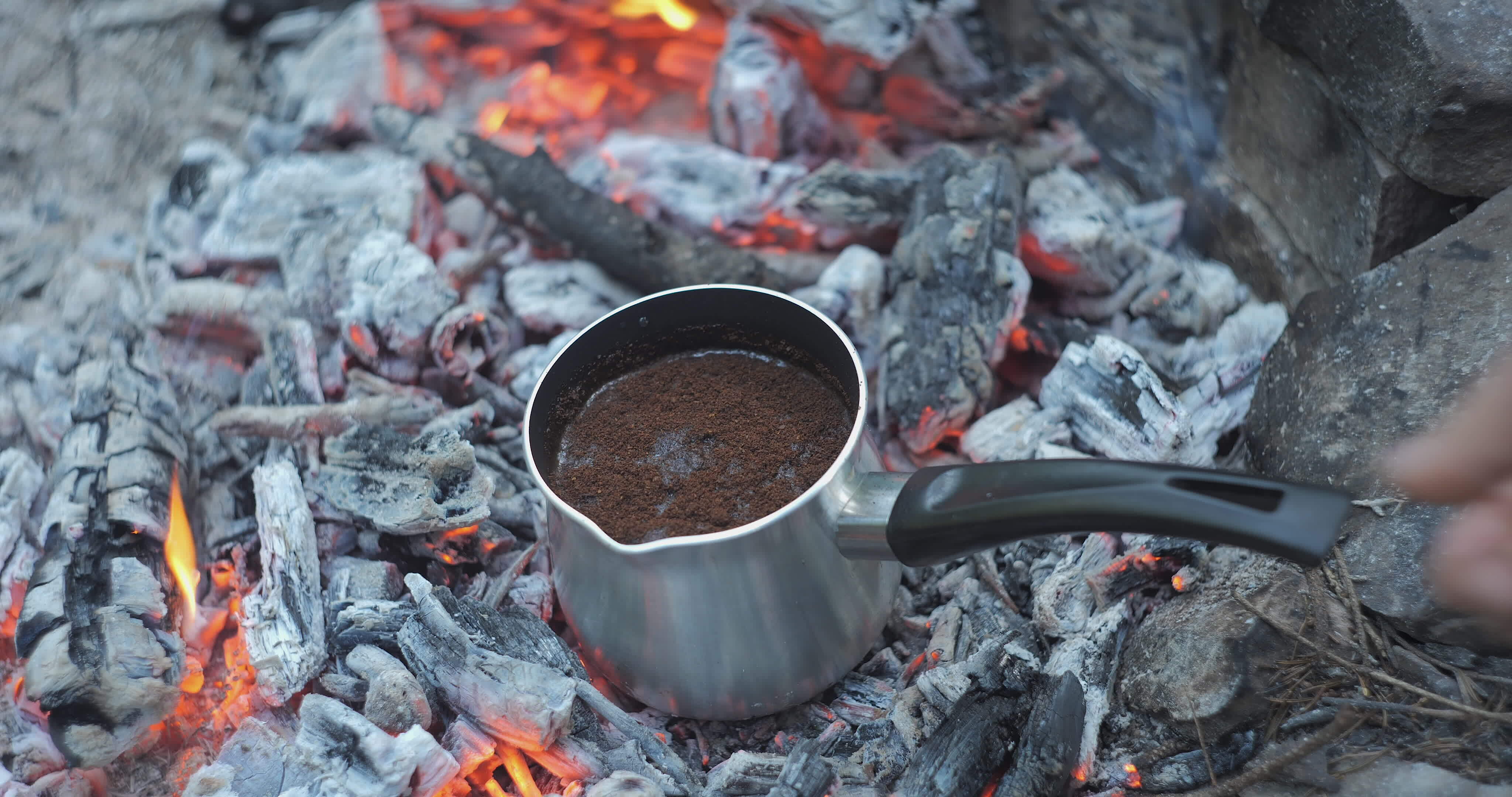 Preparing coffee on coals in a coffee maker. Brewing coffee on a
