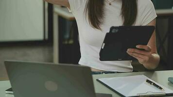 Business team working with new startup project plan and discussion information for financial strategy with laptop and digital tablet in a modern business lounge. video