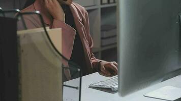 Beautiful female call center operator working on computer in office video