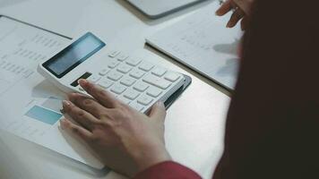 Business team working with new startup project plan and discussion information for financial strategy with laptop and digital tablet in a modern business lounge. video