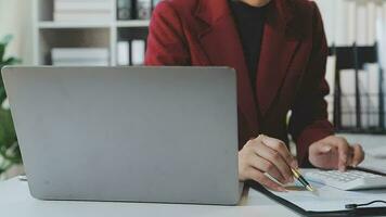 Business team working with new startup project plan and discussion information for financial strategy with laptop and digital tablet in a modern business lounge. video