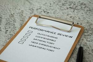 Performance Review checklist on clip board with pen. Performance review concept. photo