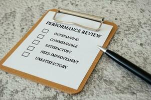 Performance Review checklist on clip board with pen. Performance review concept photo