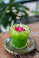 Kale juice in a glass on a wooden table photo