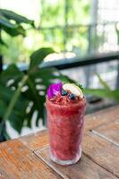 Smoothie juice in a glass on a wooden table photo