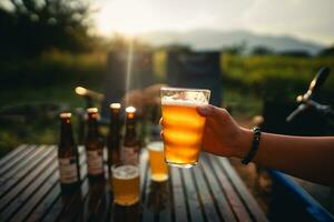 Beer on the table and camping party,hands toasting in beer, photo