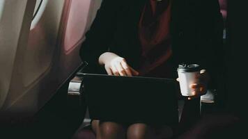 Asian young woman using laptop sitting near windows at first class on airplane during flight,Traveling and Business concept video